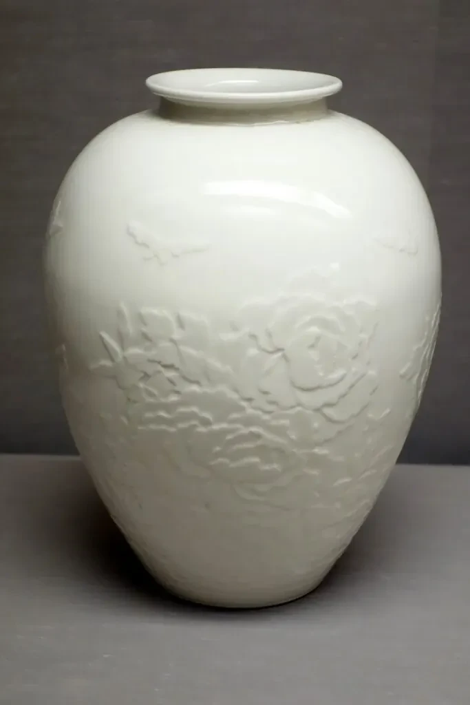 Large white porcelain vase, peonies and butterflies in relief
